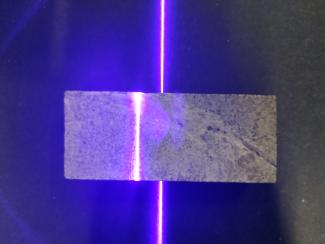 Querschnitt eines Gesteinbohrkerns mit Laserbeleuchtungslinie